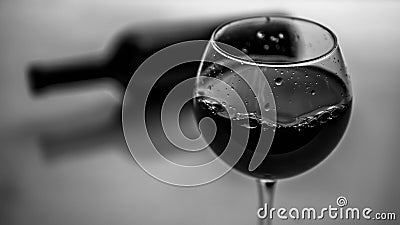 Red wine in a glass black and white picture, a bottle of wine with a glass of wine. Stock Photo