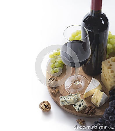 Red wine, glass, grapes, cheese and nuts Stock Photo