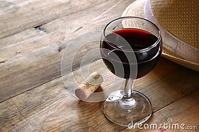 Red wine glass wooden table at sunset burst. vintage filtered image Stock Photo