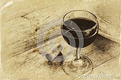 Red wine glasson wooden table. vintage filtered image. black and white style photo Stock Photo