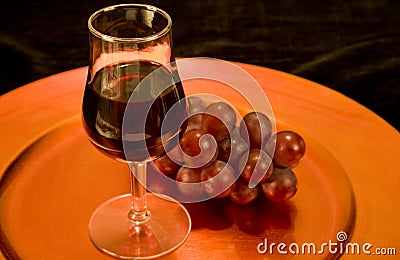 Red wine and grapes on a tray Stock Photo