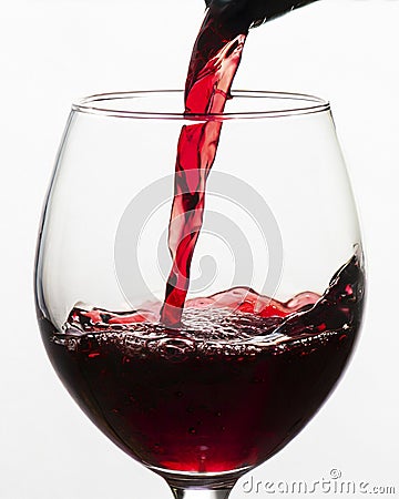 red wine pouring into glass Stock Photo