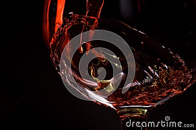 Red wine pours into a glass Stock Photo