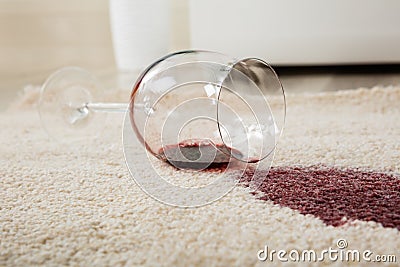 Red Wine Spilled From Glass On Carpet Stock Photo