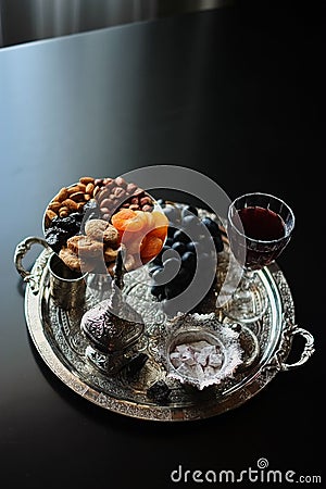 Red wine, wineglass with walnuts, grapes and figs on dark wooden background Stock Photo