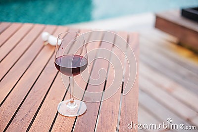 Red wines glasses near swimming pool. Summer travel, vacation, holiday and happy weekend concept Stock Photo