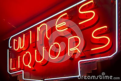 Red wines and liquors neon lights on an interior wall Stock Photo