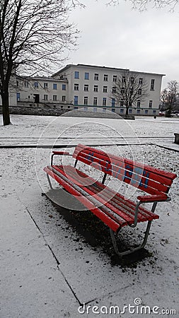 Red wood bench into snow Stock Photo