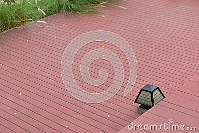 Red wood patio floor and lamp light decor in garden Stock Photo