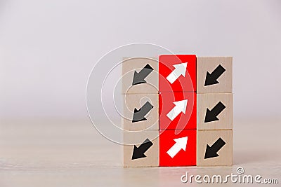Red wooden blocks with white arrows facing opposite to the black arrows. Stock Photo