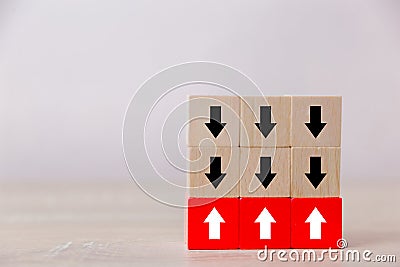 Red wooden blocks with white arrows facing opposite to the black arrows. Stock Photo