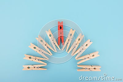 Red wooden clothespin - standing out from the crowd, concept of difference Stock Photo