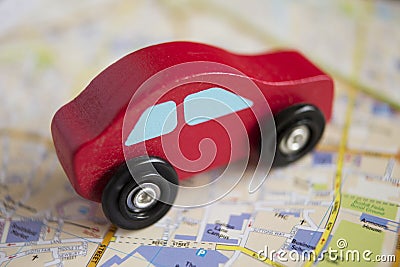 Red Wooden Toy Car On Road Map Stock Photo