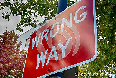 Red wrong way sign on a post Stock Photo