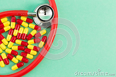 Red and yellow antibiotics and stethoscope Stock Photo