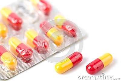 Red and yellow capsule pills in blister isolated Stock Photo