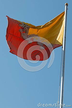 The red and yellow flag of Bhutan flying over Punakha dzong, Bhutan Editorial Stock Photo