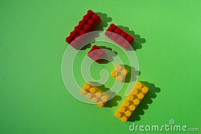 Red and yellow kids designer details isolated on green background with copy space Stock Photo