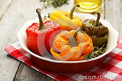 Red and yellow peppers stuffed with the meat, rice and vegetables Stock Photo