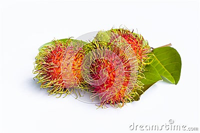 Red and yellow rambutan fruit and its leaves Stock Photo