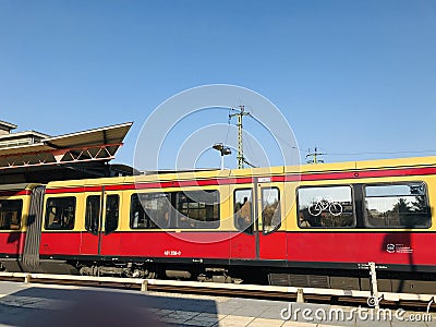 Red and yellowish traditional S Bahn train in a platform in Berlin city Editorial Stock Photo