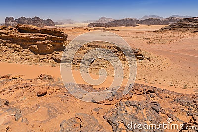 Reddish sand and rock landscapes in the desert of Wadi Rum, southern Jordan Stock Photo