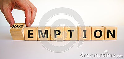 Redemption or emption symbol. Male hand turns a wooden cube and changes the word `emption` to `redemption`. Beautiful white Stock Photo
