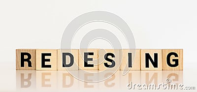 REDESIGN word made with building blocks Stock Photo