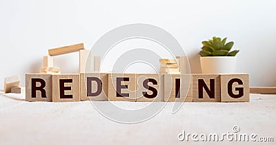 REDESIGN word made with building blocks, concept Stock Photo