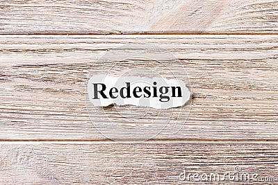 REDESIGN of the word on paper. concept. Words of REDESIGN on a wooden background Stock Photo
