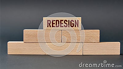 REDESIGN - word on wooden blocks on dark background Stock Photo