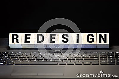 REDESIGN word written on wood block Stock Photo