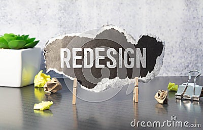 REDESIGN word written on wood block. REDESIGN text on wooden table for your desing, concept Stock Photo