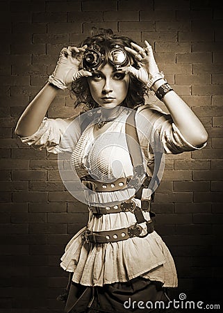 Redhair girl with steampunk goggles. Old-fashioned. Stock Photo