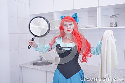 Redhaired plus size angry sad woman holding frying pan Stock Photo