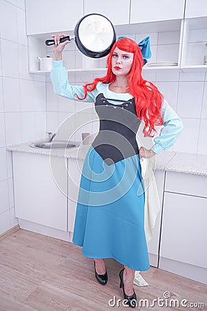 Redhaired plus size angry sad woman holding frying pan Stock Photo