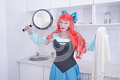 Redhaired plus size angry sad woman holding frying pan Stock Photo