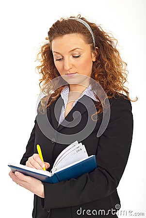 Redhead business woman writing in agenda Stock Photo