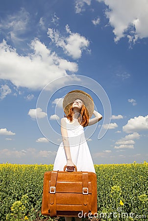 Redhead enchantress with suitcase Stock Photo