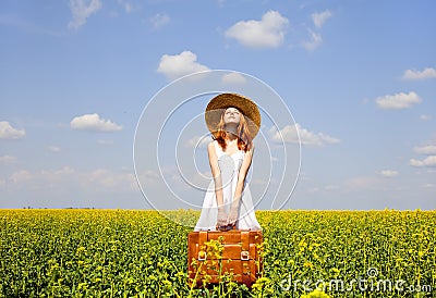 Redhead enchantress with suitcase Stock Photo