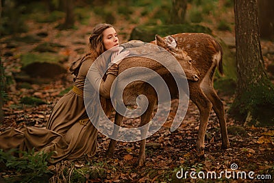 Redhead girl with deer in a long dress Stock Photo