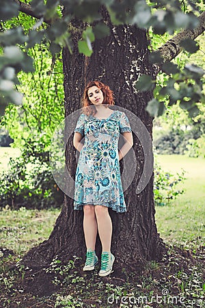 Redhead girl in park Stock Photo