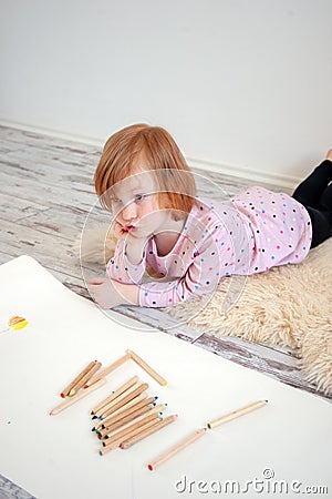 The girl thinks what else to draw Stock Photo