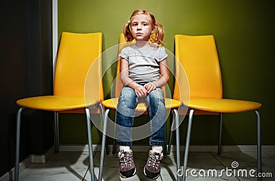Redhead girl waiting in reception room. Stock Photo