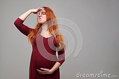 Redhead pregnant woman feeling bad of upleasant smell Stock Photo