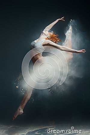 Redhead woman dancer in dust Stock Photo