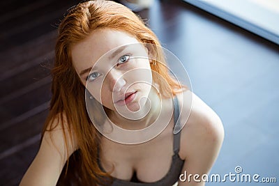 Redhead woman sitting on the floor Stock Photo