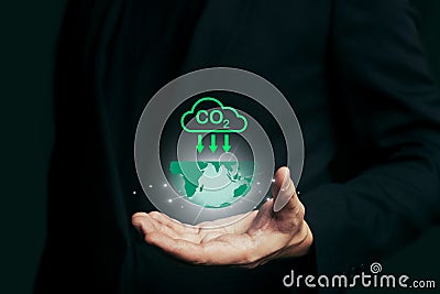 Reduce CO2 emission concept in the hand with icons, global warming for environmental.Net zero and carbon neutral concept Stock Photo