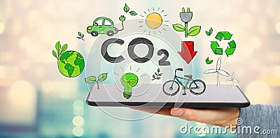 Reduce CO2 with man holding a tablet Stock Photo