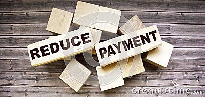 Reduce payment words formed by wooden blocks Stock Photo